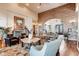 Inviting living room featuring a brick accent wall, hardwood floors, and comfortable seating at 6963 S Espana Way, Centennial, CO 80016