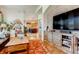 Stylish living room showcasing hardwood floors, a fireplace, and an open layout connected to the kitchen at 6963 S Espana Way, Centennial, CO 80016