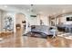 Spacious living room with hardwood floors, a brick bar area, and an open floor plan at 6963 S Espana Way, Centennial, CO 80016
