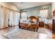 Serene main bedroom featuring hardwood floors, large windows, and elegant decor at 6963 S Espana Way, Centennial, CO 80016
