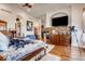 Spacious main bedroom with a fireplace, hardwood floors, and plenty of natural light at 6963 S Espana Way, Centennial, CO 80016