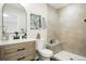 Modern bathroom with wood vanity, stylish shower, and neutral tones at 5541 E 65Th Ave, Commerce City, CO 80022
