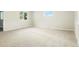 Bright bedroom featuring neutral carpet, fresh paint, and double pane windows at 5541 E 65Th Ave, Commerce City, CO 80022