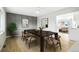 Dining room with a paneled wall, modern chandelier, and view to the living room at 5541 E 65Th Ave, Commerce City, CO 80022