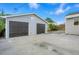Large detached two-car garage with a concrete driveway and adjacent yard at 5541 E 65Th Ave, Commerce City, CO 80022