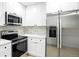 A close up of the kitchen's stainless steel microwave, range, and refrigerator at 5541 E 65Th Ave, Commerce City, CO 80022