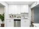 Modern kitchen features white cabinets, stainless steel appliances, and sleek countertops at 5541 E 65Th Ave, Commerce City, CO 80022