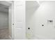 Utility room with washer and dryer hookups and white marbled vinyl flooring at 5541 E 65Th Ave, Commerce City, CO 80022
