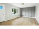 Open living space featuring hardwood floors, a neutral color palette, and a large window at 5541 E 65Th Ave, Commerce City, CO 80022