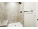 Beautiful tile shower featuring a built-in seat and modern fixtures at 5541 E 65Th Ave, Commerce City, CO 80022
