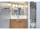 Bathroom with granite countertop vanity and combination shower-tub with tile surround at 1125 N Washington St # 303, Denver, CO 80203