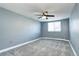 This bedroom features carpeted floors, a ceiling fan, and a window with blinds at 1125 N Washington St # 303, Denver, CO 80203