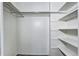 A simple closet with open shelving and a rod for hanging clothes is shown at 1125 N Washington St # 303, Denver, CO 80203