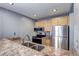 This kitchen has wooden cabinets, granite countertops, and stainless appliances at 1125 N Washington St # 303, Denver, CO 80203