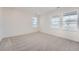A carpeted bedroom with three windows provides bright natural light at 2090 S Haleyville Way, Aurora, CO 80018