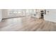 Bright living room featuring hardwood floors, large windows, and an open floor plan into the kitchen at 2090 S Haleyville Way, Aurora, CO 80018