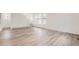 Minimalist living room with bright white walls and wide plank flooring at 2090 S Haleyville Way, Aurora, CO 80018