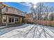 Backyard with snow, deck and wooden fence at 7757 S Nevada Dr, Littleton, CO 80120