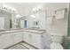 Bright bathroom featuring double sinks, modern fixtures, and a toilet at 19019 E Warren Dr # H104, Aurora, CO 80013