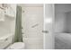 Bright bathroom featuring a shower and tub combination with white tiling and green shower curtain at 19019 E Warren Dr # H104, Aurora, CO 80013