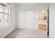 Sunlit bedroom with plush carpet and a bright window, offering seamless flow to other areas at 19019 E Warren Dr # H104, Aurora, CO 80013