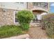 Charming stone accented condo exterior with lush landscaping at 19019 E Warren Dr # H104, Aurora, CO 80013