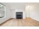Bright living room featuring a fireplace, laminate floors and lots of natural light at 19019 E Warren Dr # H104, Aurora, CO 80013