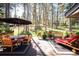 Expansive deck features dining and lounge areas, surrounded by lush forest, perfect for outdoor relaxation and entertaining at 28454 Meadow Dr, Evergreen, CO 80439