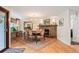 Elegant dining room featuring a stone fireplace, a chandelier, and hardwood floors at 28454 Meadow Dr, Evergreen, CO 80439