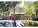 Charming multi-level home featuring a stone facade, inviting front porch, and a well-maintained lawn at 28454 Meadow Dr, Evergreen, CO 80439