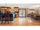 Bright kitchen featuring stainless steel appliances, a breakfast bar, and an adjacent dining area and deck access at 28454 Meadow Dr, Evergreen, CO 80439