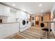 Spacious laundry room with storage, a modern washer and dryer, and work space at 28454 Meadow Dr, Evergreen, CO 80439