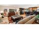 Comfortable living area with hardwood floors, a large TV, and stylish furnishings flowing into the kitchen at 28454 Meadow Dr, Evergreen, CO 80439