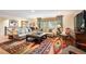 Inviting living room featuring stylish sofas, a unique rug, and a bright window showcasing natural light at 28454 Meadow Dr, Evergreen, CO 80439