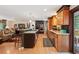 Open concept living area featuring hardwood floors, modern appliances, a kitchen island and comfortable seating at 28454 Meadow Dr, Evergreen, CO 80439