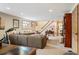 A spacious living room with lots of room to spread out, bright light, and a staircase at 28454 Meadow Dr, Evergreen, CO 80439