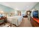 Large main bedroom suite featuring a plush bed, seating area, and neutral tones at 28454 Meadow Dr, Evergreen, CO 80439