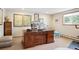 Home office with large desk, built-in storage, bright window, and neutral decor at 28454 Meadow Dr, Evergreen, CO 80439