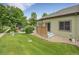 Grassy back yard with patio, privacy fence, and well-manicured landscaping at 4501 S Tabor Ct, Morrison, CO 80465