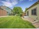 The well-maintained back yard features a grassy lawn, patio, and privacy fence at 4501 S Tabor Ct, Morrison, CO 80465