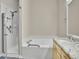 Bright bathroom features a tiled shower, jetted tub, granite countertops, and modern fixtures at 4501 S Tabor Ct, Morrison, CO 80465