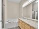 Bathroom featuring a large soaking tub, vanity with granite counters, and a glass-enclosed shower at 4501 S Tabor Ct, Morrison, CO 80465