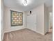Carpeted bedroom features a closet, neutral walls, overhead lighting, and decorative wall-hanging at 4501 S Tabor Ct, Morrison, CO 80465
