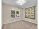 This bedroom features a neutral carpet, double windows with shutters, and a quaint, decorative quilt at 4501 S Tabor Ct, Morrison, CO 80465