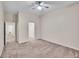 Large bedroom with neutral color palette, ceiling fan, and view into an open hallway at 4501 S Tabor Ct, Morrison, CO 80465