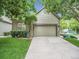 Attached garage with stone accents and well manicured yard of the home at 4501 S Tabor Ct, Morrison, CO 80465