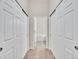 Hallway view to the bathroom showing access to a tub and closet space at 4501 S Tabor Ct, Morrison, CO 80465