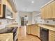Well-lit kitchen featuring wooden cabinets, granite countertops, and modern appliances at 4501 S Tabor Ct, Morrison, CO 80465