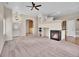 Cozy living room featuring a fireplace, neutral walls, and access to other rooms at 4501 S Tabor Ct, Morrison, CO 80465
