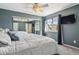 A calm bedroom with a comfortable bed, mirrored closet doors, and a window with natural light at 9519 Devon Ct, Highlands Ranch, CO 80126